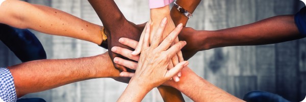 Hands stacked in center of group